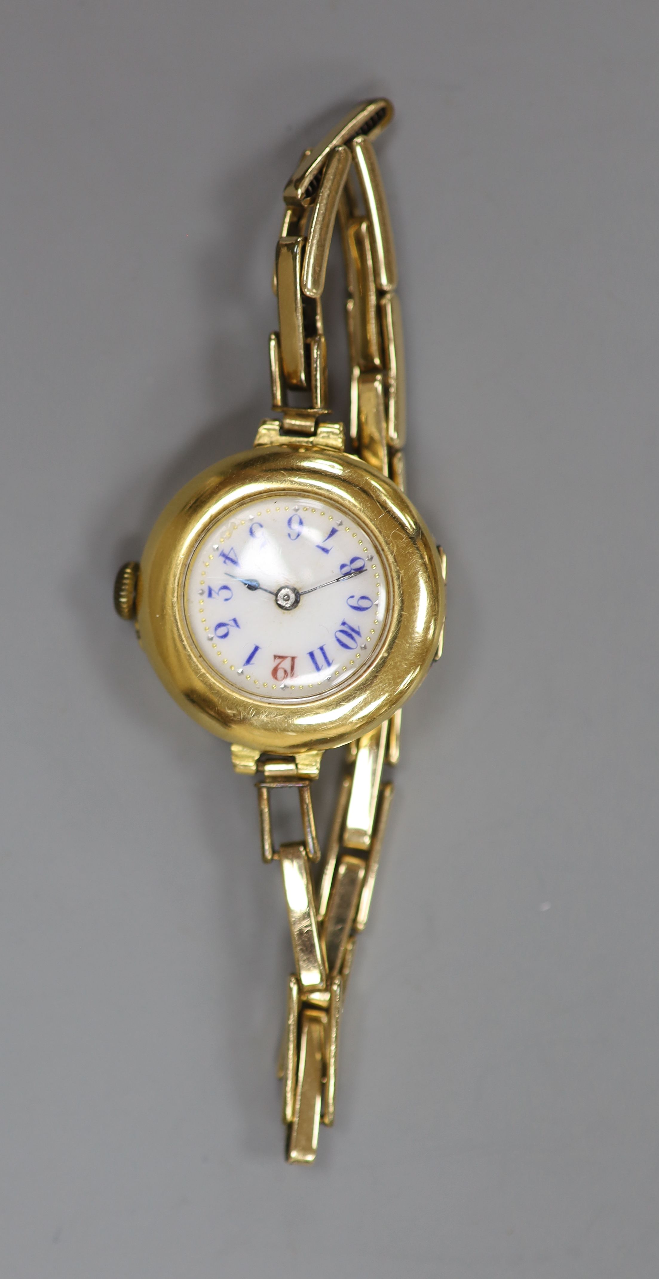 A ladys early 20th century continental 18c yellow metal manual wind wrist watch on gold plated bracelet, gross 22.3 grams,